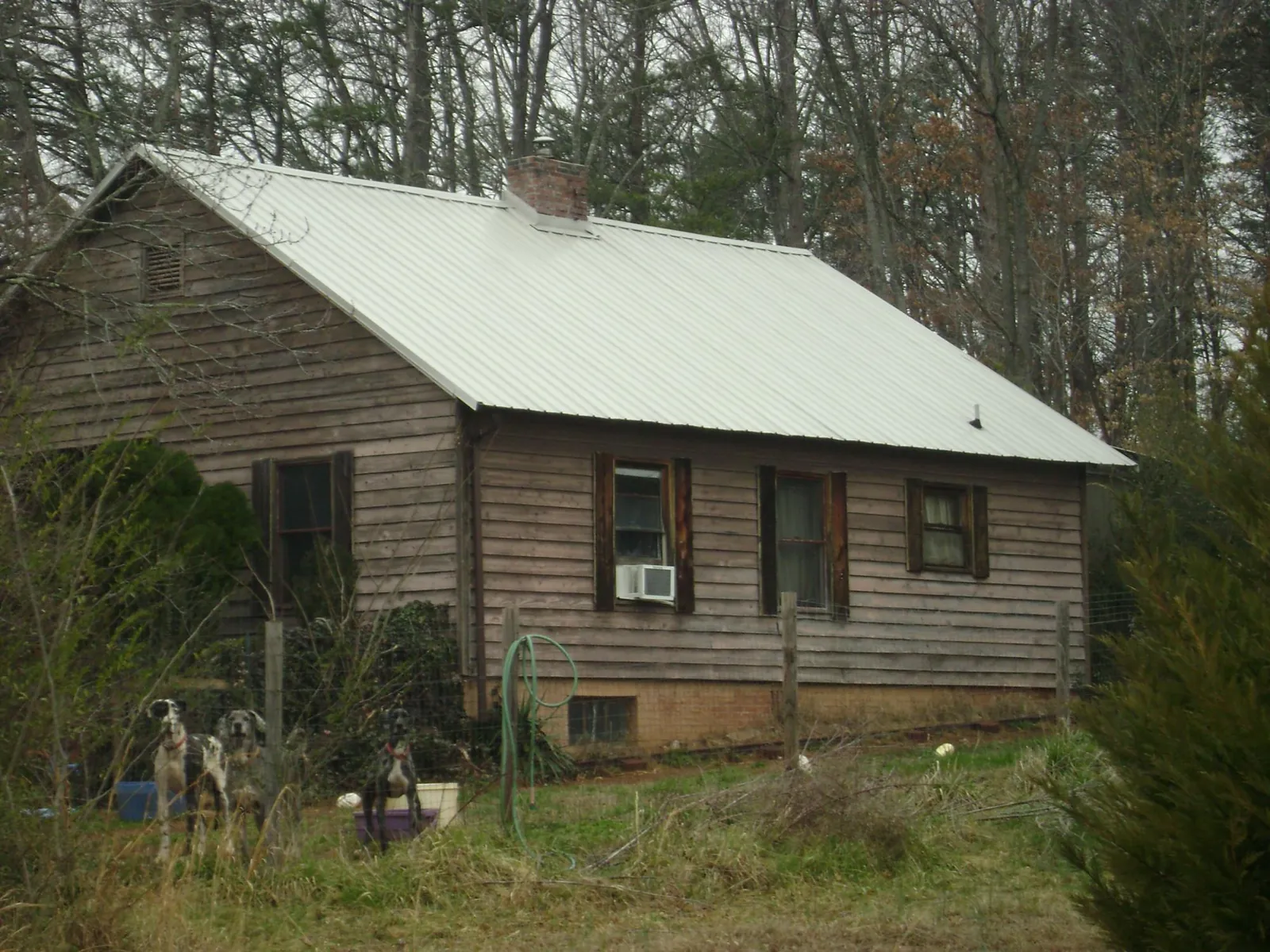 White metal roof on an old wood sided farmhouse, from a Metal Roof Installation job in Watson